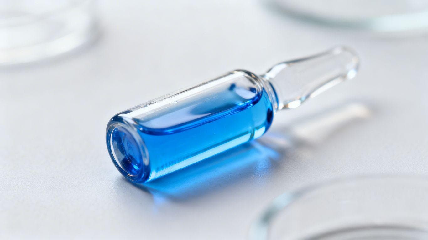 GHK-Cu peptide vial with blue liquid.